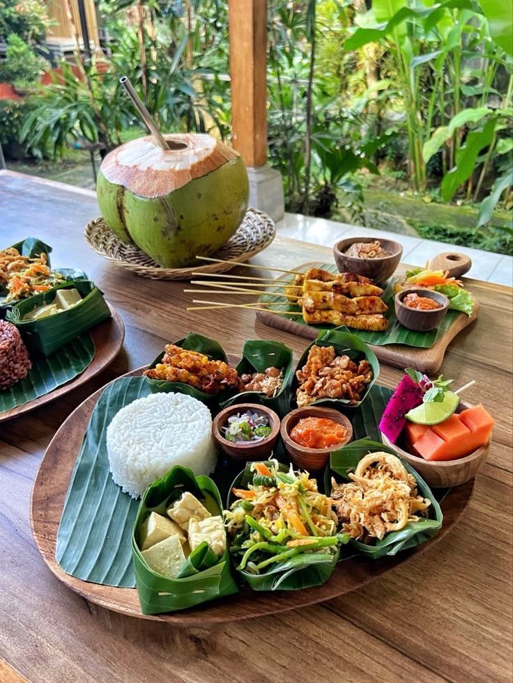 Sri Lankan rice and curry served on banana leaves with a fresh coconut
